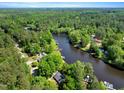 Stunning aerial view of a waterfront community surrounded by dense forests and a winding river at 135 Sagamore Dr, Louisburg, NC 27549