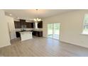 Open kitchen with dark cabinets, granite countertops, stainless appliances, island and adjacent dining area at 147 Gobbler Dr, Smithfield, NC 27577