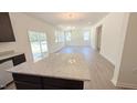 Open-concept living room with hardwood floors, natural light, and a view of the backyard at 147 Gobbler Dr, Smithfield, NC 27577