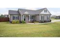 Inviting single-story home with manicured lawn and a charming covered porch at 18 Fisher Rd, Lillington, NC 27546