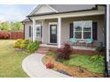 Well-maintained home with a charming front yard, walkway, and inviting porch seating at 18 Fisher Rd, Lillington, NC 27546