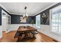 Inviting dining room featuring a wooden table, comfortable bench seating, and natural light at 1816 Albacore Ln, Raleigh, NC 27612
