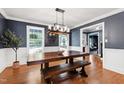 Elegant dining room with a wooden table, bench seating, and stylish chandelier at 1816 Albacore Ln, Raleigh, NC 27612