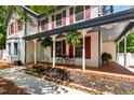 Inviting front porch with brick flooring, detailed columns, and ample seating space at 1816 Albacore Ln, Raleigh, NC 27612