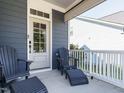 Cozy covered front porch with comfortable chairs, perfect for enjoying the outdoors at 1941 Bright Kannon Way, Wendell, NC 27591