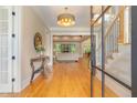 Inviting foyer boasts hardwood floors and an open floor plan flowing into the living room and staircase at 2016 Falls Forest Dr, Raleigh, NC 27615