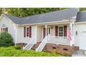 Home with red shutters and a quaint front porch at 205 Smiths Creek Dr, Clayton, NC 27520