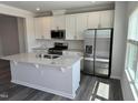 Modern kitchen featuring stainless steel appliances, a center island, and white cabinets at 2118 Terrawood Dr, Durham, NC 27703