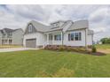 Beautiful single Gathering home with a 2-car garage, white siding, a covered porch and green grass at 24 Sanders Farm Dr, Smithfield, NC 27577