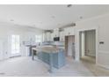 Bright kitchen features an island, modern white cabinets, and stainless steel appliances at 25 Sanders Farm Dr, Smithfield, NC 27577
