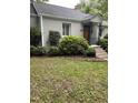 Well-maintained home showcasing lush landscaping and an attractive front entrance with decorative ironwork at 2823 Fowler Ave, Raleigh, NC 27607