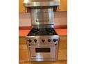 Stainless steel Viking range with four burners, griddle, and hood at 2823 Fowler Ave, Raleigh, NC 27607