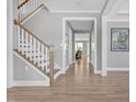 Inviting entryway with hardwood floors, staircase, and views into the living spaces at 2848 Angelica Rose Way, Apex, NC 27502