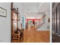 Inviting foyer with hardwood floors, a staircase, and views into the living spaces at 30119 Settle, Chapel Hill, NC 27517