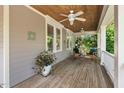 Relaxing covered porch with ceiling fans, comfortable seating, and a wooden ceiling at 30119 Settle, Chapel Hill, NC 27517
