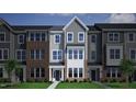 Charming exterior view of townhomes featuring a mix of siding and brick accents, enhancing the neighborhood's curb appeal at 335 Chesapeake Cmns St # 107, Garner, NC 27529
