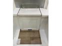 Sample of design materials that includes white cabinets, light countertops, subway tile, and wood-look luxury vinyl flooring at 335 Chesapeake Cmns St # 107, Garner, NC 27529