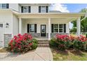 Inviting front porch with red roses, perfect for relaxing and enjoying the neighborhood ambiance at 3409 Lemon Springs Rd, Sanford, NC 27332