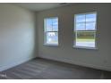 Cozy bedroom with carpeted floors, two windows, and great natural light at 38 Gander Dr, Benson, NC 27504
