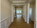 Hallway with elegant trim and wood floors lead to other areas of the home at 38 Gander Dr, Benson, NC 27504