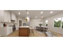 Bright kitchen featuring white cabinets, marble countertops, and stainless steel appliances at 406 Chatham View Rd, Cary, NC 27511