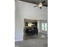 Open dining area featuring hardwood floors, modern lighting, and an adjacent open kitchen space at 42 Hemming Ct, Cameron, NC 28326