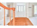 Inviting foyer with hardwood floors and a view of the front door with sidelights at 4404 Triland Way, Cary, NC 27518