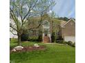 Beautiful two-story brick home with lush green lawn and mature landscaping at 4404 Triland Way, Cary, NC 27518