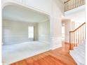 Large living room with hardwood floors, neutral walls, and a staircase with carpeted steps at 4404 Triland Way, Cary, NC 27518