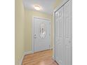 Bright entryway featuring a decorative glass front door and closet at 4705 Forest Highland Dr, Raleigh, NC 27604