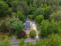 Aerial view of the white house with dark shingles and detached two car garage at 4713 Erwin Rd, Durham, NC 27705