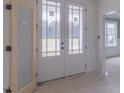 Bright foyer showcases glass paned double doors and a glimpse of the spacious interior and outdoor views at 48 Sanders Farm Dr, Smithfield, NC 27577