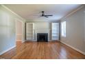 Bright living room with hardwood floors, fireplace, built-in shelves and ceiling fan for comfortable living at 4813 Glen Forest Dr, Raleigh, NC 27612