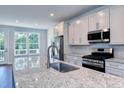 Bright kitchen featuring granite countertops, stainless steel appliances, and a large window above the sink at 509 Sherron Rd # 30, Durham, NC 27703
