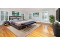 Spacious bedroom showcasing hardwood floors, ample natural light, and stylish decor at 5513 Parkwood Dr, Raleigh, NC 27612