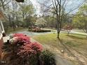 Scenic property with winding driveway, colorful landscaping, and mature trees at 5517 Spring Rd, Raleigh, NC 27603