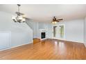Inviting living room boasts hardwood floors, a cozy fireplace, and easy access to the outdoors through glass doors at 5622 Osprey Cove Dr, Raleigh, NC 27604