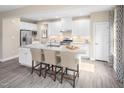 Bright kitchen features a large center island, granite countertops, and stainless steel appliances at 568 Impala, Wendell, NC 27591