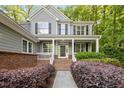 A charming front porch with brick accents and manicured landscaping welcomes you home at 606 Churton Grove Blvd, Hillsborough, NC 27278