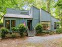 Charming home with well-maintained landscaping, an American flag and a cozy entrance at 61 Stone Ledge, Pittsboro, NC 27312
