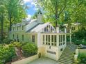 Beautiful home exterior featuring a balcony, sunroom over the garage, and well-maintained landscaping at 612 Swift Ave, Durham, NC 27701