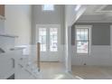 Bright foyer with large windows, natural light, wainscotting and coffered ceilings at 66 Sanders Farm Dr, Smithfield, NC 27577