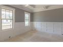 Future living room with wainscotting and large windows overlooking the front yard at 66 Sanders Farm Dr, Smithfield, NC 27577