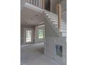 View of staircase and future living room with wainscotting and glass doors to the patio at 66 Sanders Farm Dr, Smithfield, NC 27577