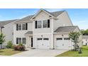 Charming two-story home featuring a two-car garage, black shutters, and well-maintained landscaping at 69 Curling Creek Dr # I286, Clayton, NC 27527