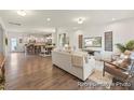 Open-concept living space seamlessly connecting the kitchen, dining, and living areas with hardwood floors at 69 Curling Creek Dr # I286, Clayton, NC 27527