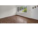 Bright bedroom with hardwood floors and large windows offering natural light at 714 W Mckinley St, Mebane, NC 27302
