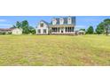 Well-maintained home with a sprawling front lawn under a bright, sunny sky at 750 James Norris Rd, Angier, NC 27501