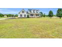 Expansive front yard with lush greenery surrounding a beautiful two-story home at 750 James Norris Rd, Angier, NC 27501