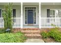 Welcoming front entrance with sidelights, steps, and classic blue door at 7805 Tuscan Ridge Dr, Wendell, NC 27591